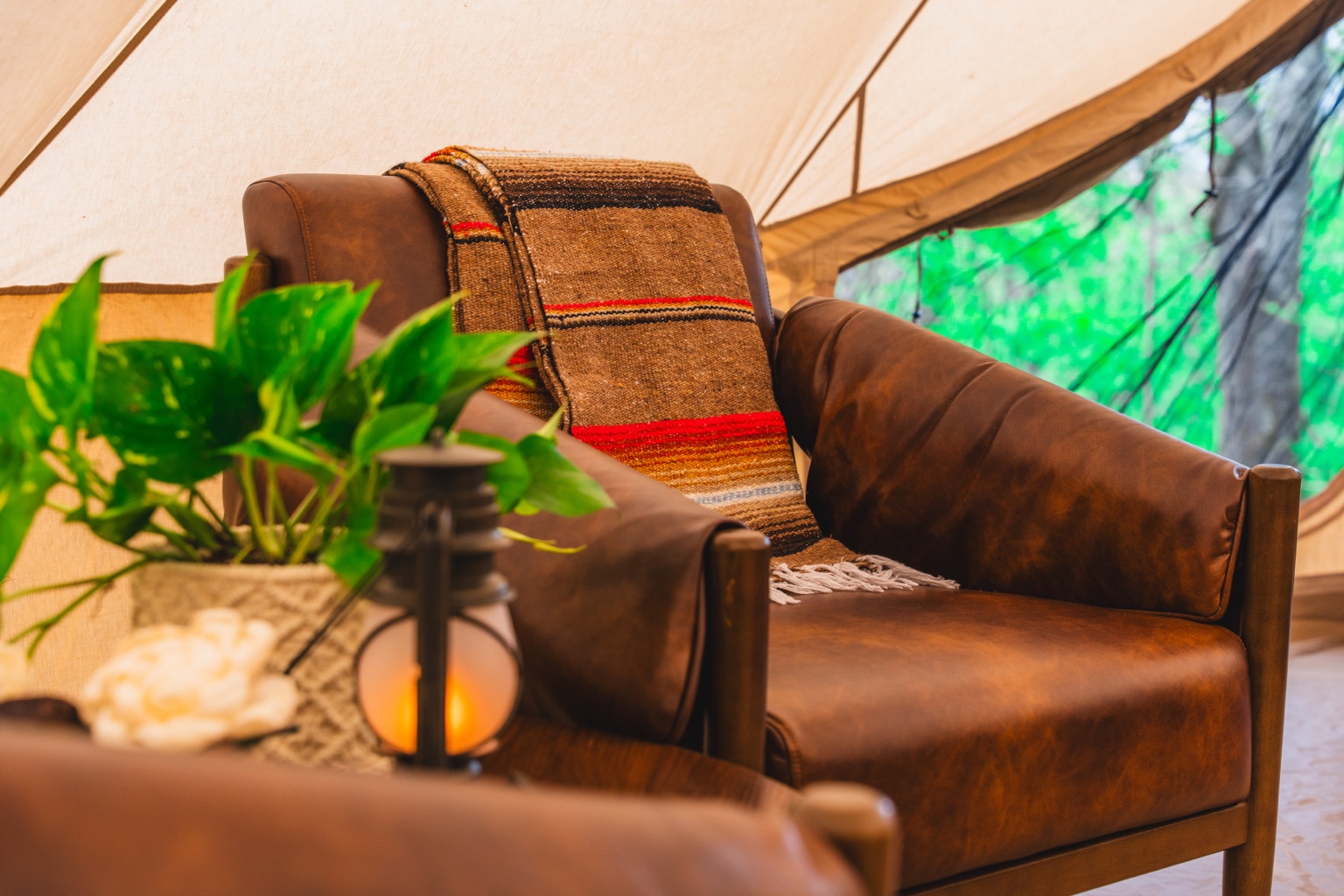 Leather chair and lantern inside the tent
