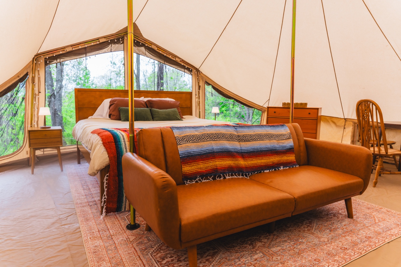 Ozark Canvas Camp interior with king bed and sofa